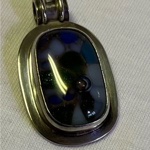 Fused Glass and Sterling Silver pendant. Has wide bezel to fit most chains.